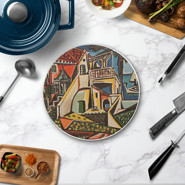 Mediterranean Landscape by Pablo Picasso Round Stone Trivet - In Context View