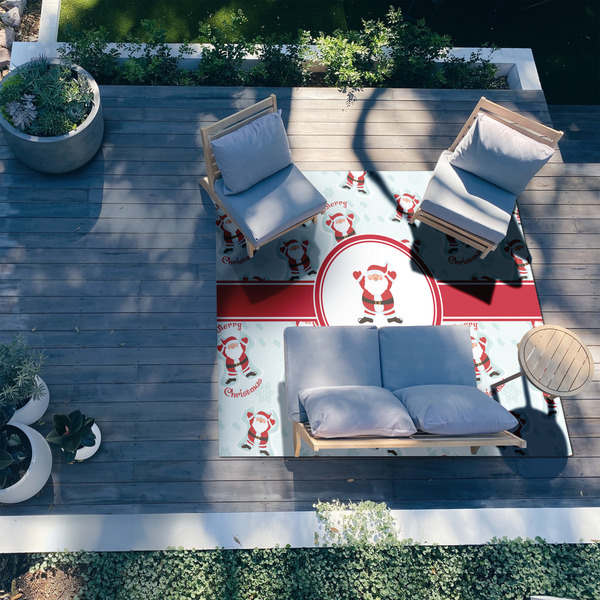 Santa Clause Making Snow Angels 8'x10' Patio Rug - In context