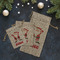 Santa Clause Making Snow Angels Burlap Gift Bags - LIFESTYLE (Flat lay)