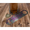 Harlequin & Peace Signs Bottle Opener - In Use