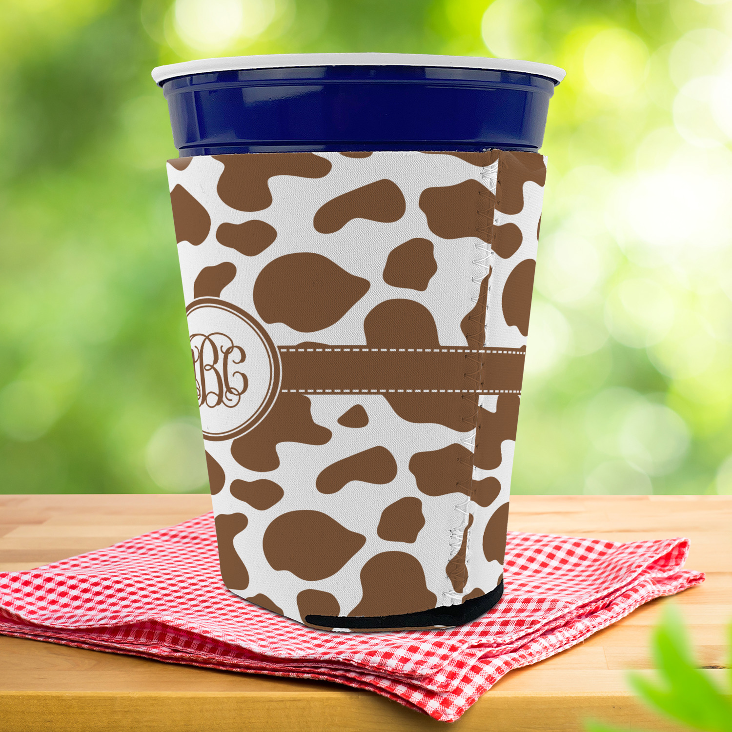 https://www.youcustomizeit.com/common/MAKE/74569/Cow-Print-Party-Cup-Sleeves-with-bottom-LIFESTYLE.jpg?lm=1671319752